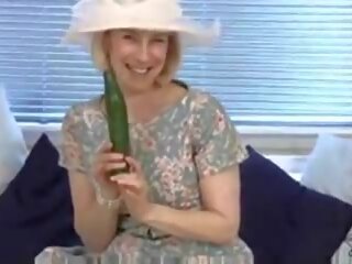 Full-blown housewife fucks a cucumber